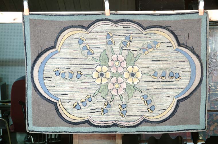 Appraisal: FLORAL HOOKED RUG Central shaped field has four flower interior