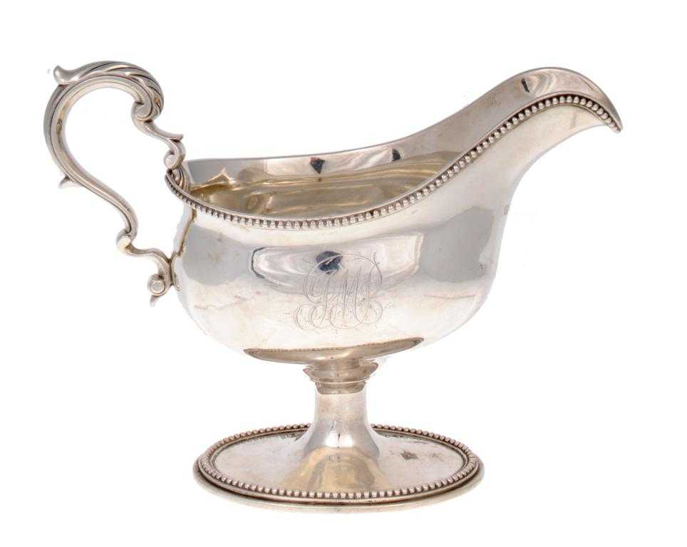 Appraisal: A GEORGE III SAUCE BOAT with leaf capped scrolling handle