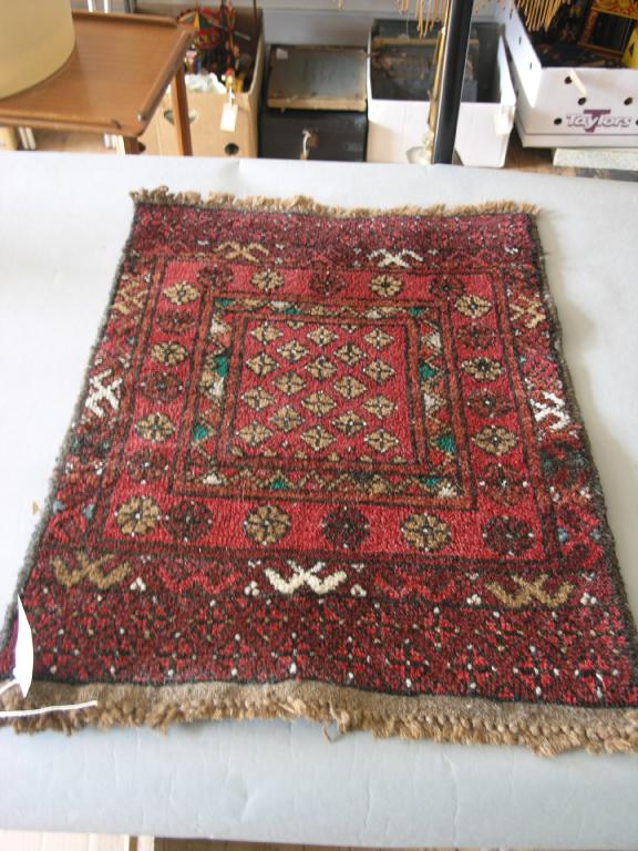 Appraisal: A small eastern wool prayer rug geometric patterns against a