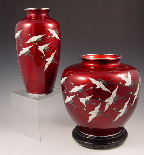 Appraisal: TWO JAPANESE PIGEON BLOOD CLOISONNE VASES Flying cranes on red