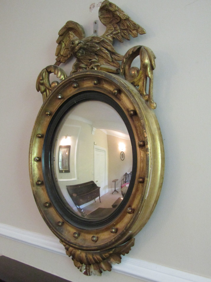 Appraisal: A Regency giltwood wall mirror with eagle surmount over scroll