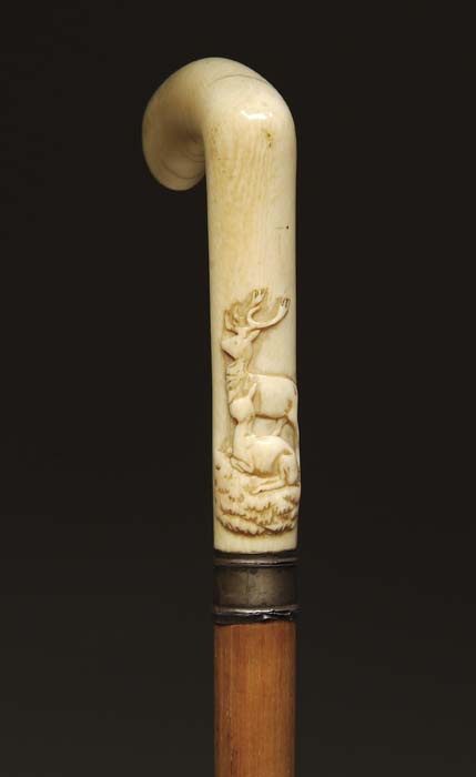 Appraisal: CARVED ANTIQUE IVORY CANE Ivory handle with raised carved stag