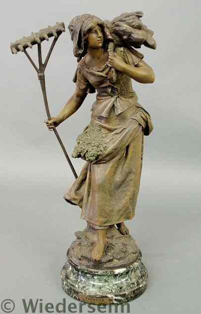 Appraisal: Faux bronze spelter metal figure of a peasant woman holding