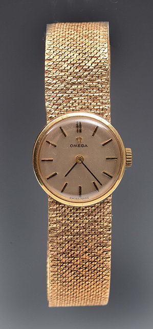 Appraisal: A ladies ct gold Omega wrist watchwith integral strap and