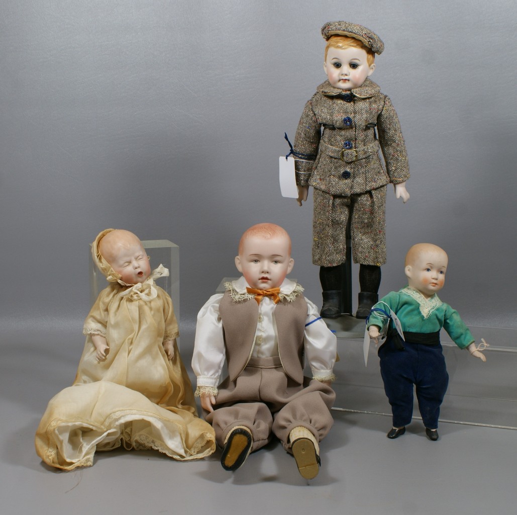 Appraisal: Reproduction German Character Dolls including American School Boy wearing tweed