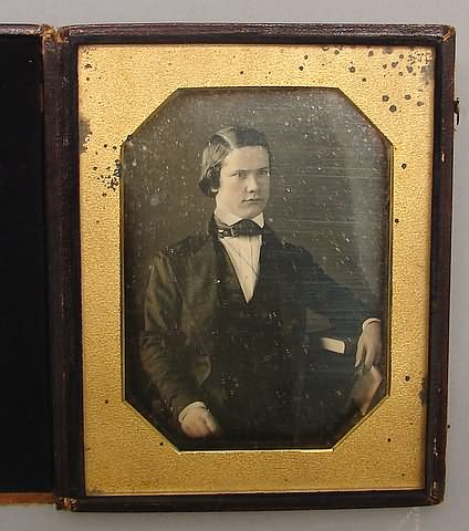 Appraisal: Half plate daguerreotype of waist-up seated boy Image exhibits some