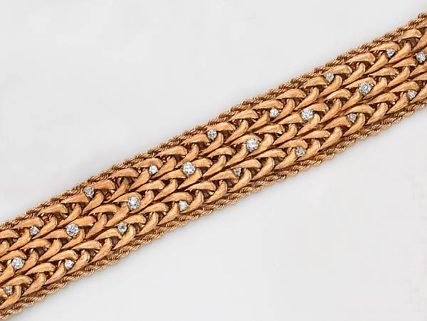 Appraisal: A diamond and fourteen karat gold bracelet the wide flexible