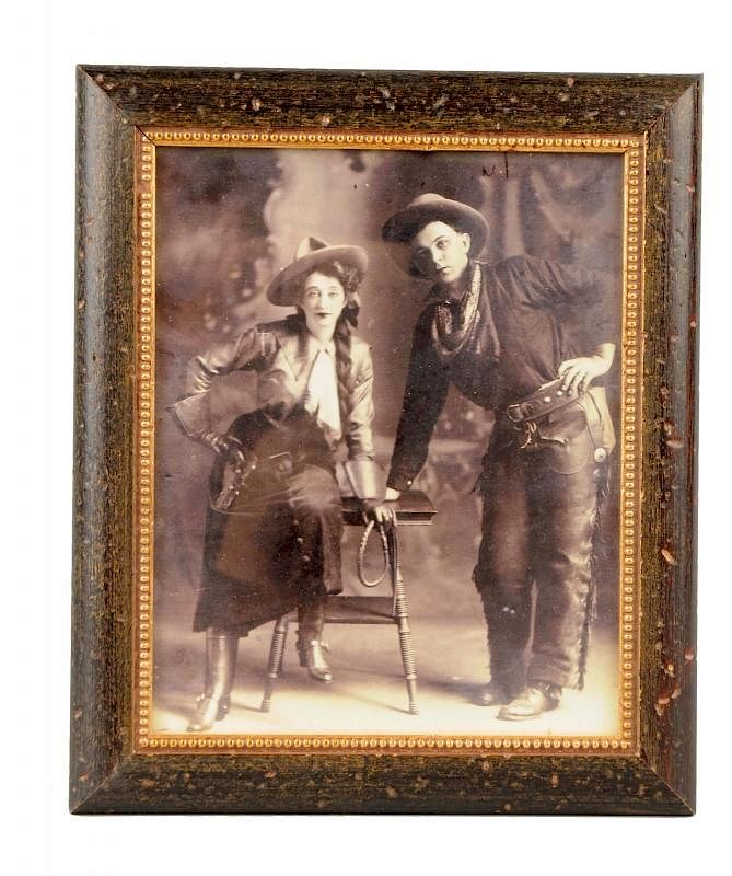 Appraisal: Framed Cowboy Cowgirl Photograph This is a photograph of a