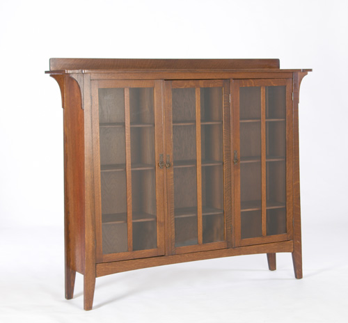 Appraisal: LIMBERT Three-door bookcase with an overhanging top supported by corbels