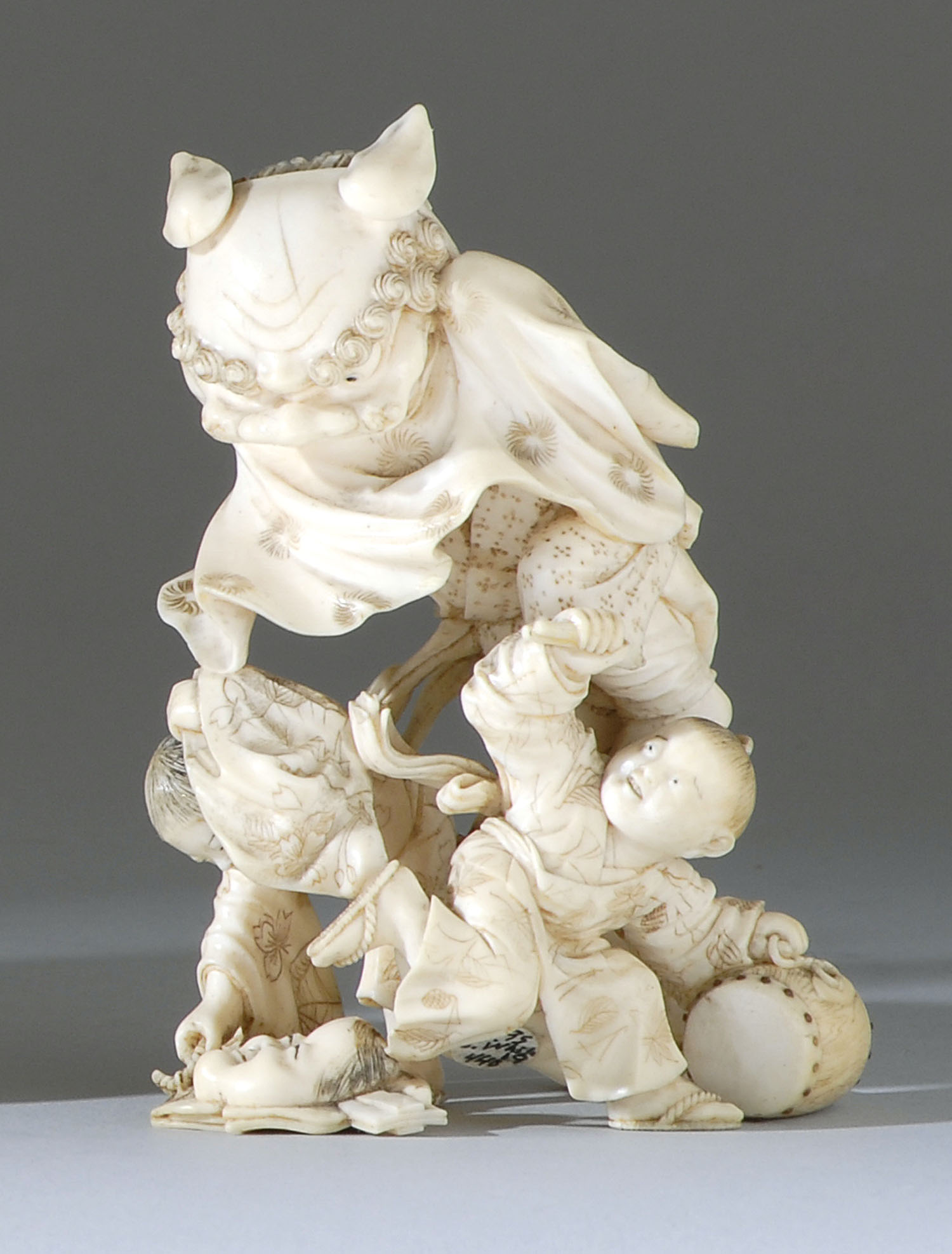 Appraisal: IVORY OKIMONO Meiji PeriodDepicting three children in a playful scene