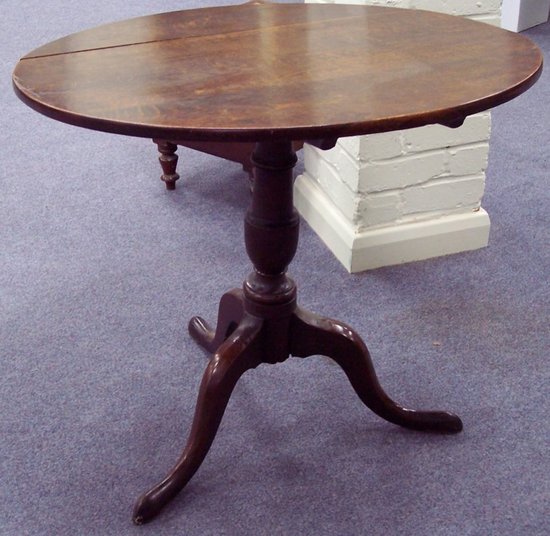 Appraisal: A th Century oak tripod table the circular top on