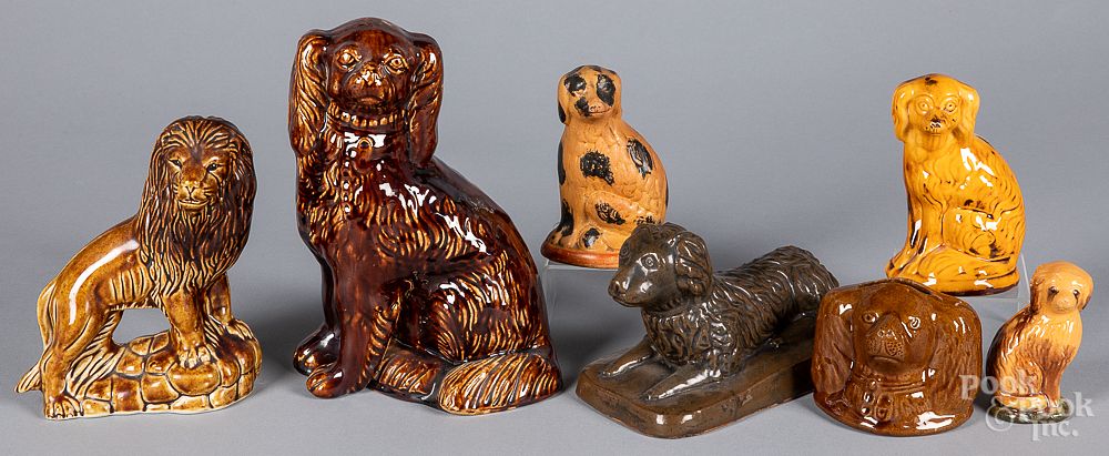 Appraisal: Seven pottery spaniels and banks Seven pottery spaniels and banks