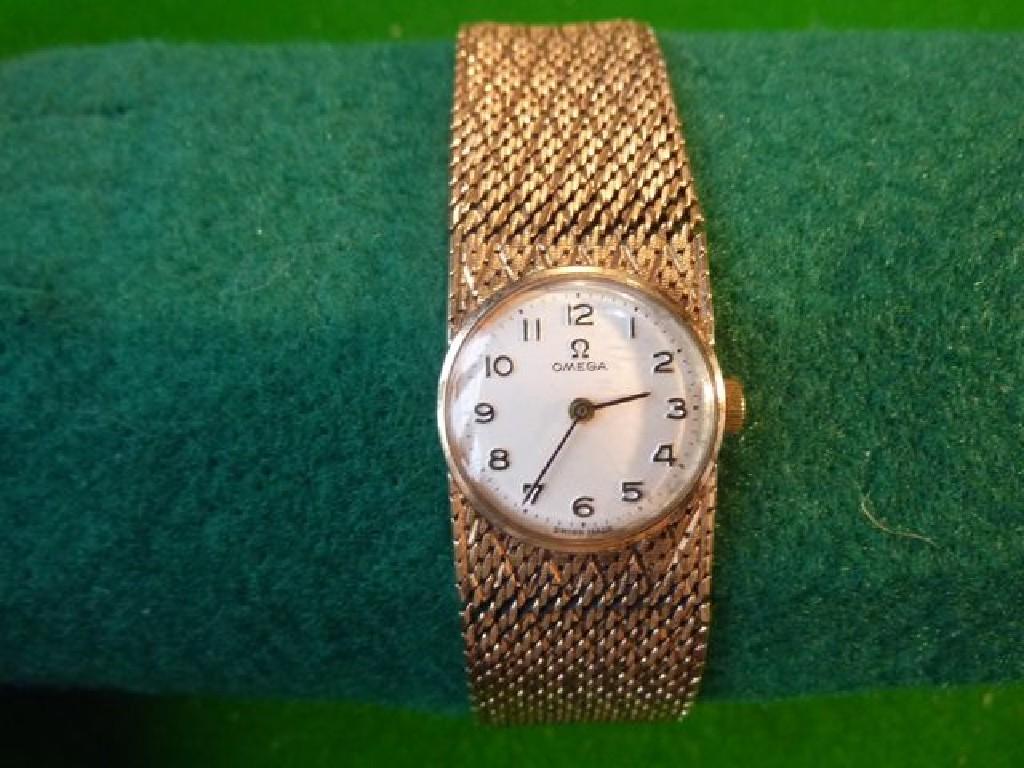 Appraisal: An Omega ladies wrist watch and woven strap in ct