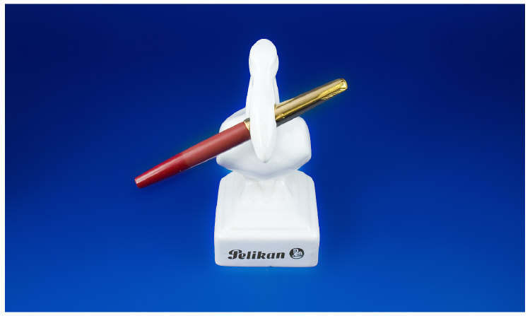 Appraisal: White Porcelain Pelikan Pen Holder Holding a Parker pen in