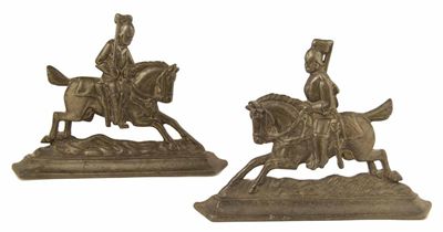 Appraisal: A pair of cast iron door stops mounted cavalrymen in