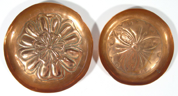 Appraisal: Two Keswick circular copper dishes embossed with floral heads impressed