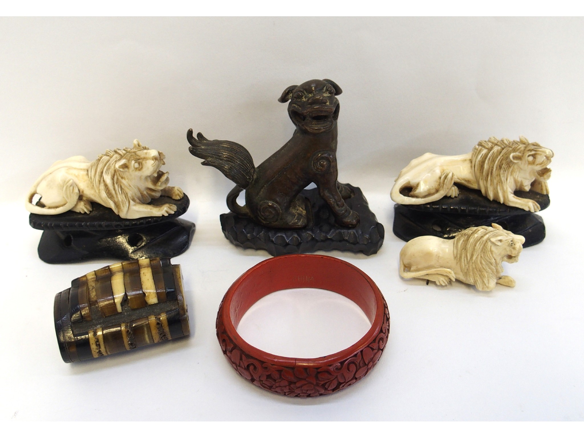 Appraisal: Bronzed metal Fo dog on stand two carved ivory lions