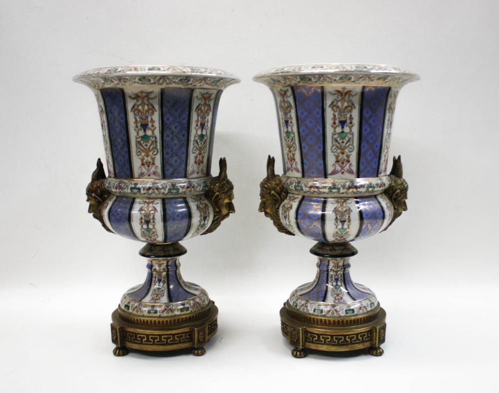 Appraisal: PAIR OF UNITED WILSON PORCELAIN AND BRONZE URNS hand painted