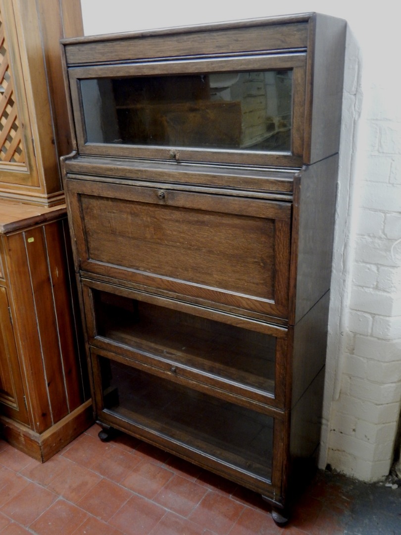 Appraisal: A mid thC stained oak sectional bookcase in Globe Wernicke