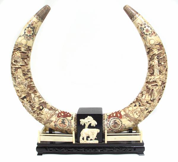 Appraisal: A pair of Chinese carved bone veneer and polychrome tusks