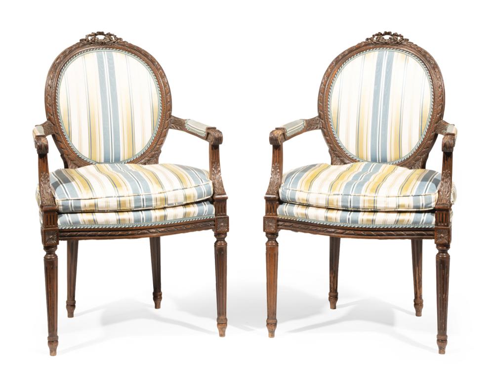 Appraisal: Pair of Louis XVI-Style Carved Fruitwood Fauteuils oval back surmounted