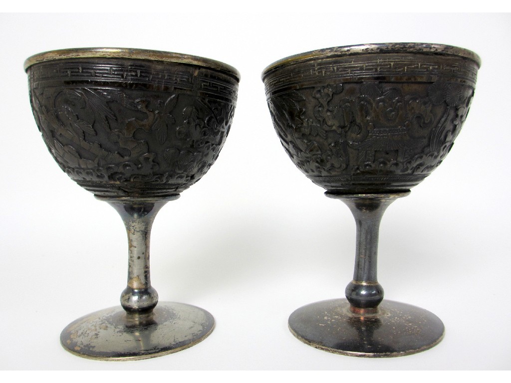 Appraisal: A pair of Chinese coconut and white metal cups carved