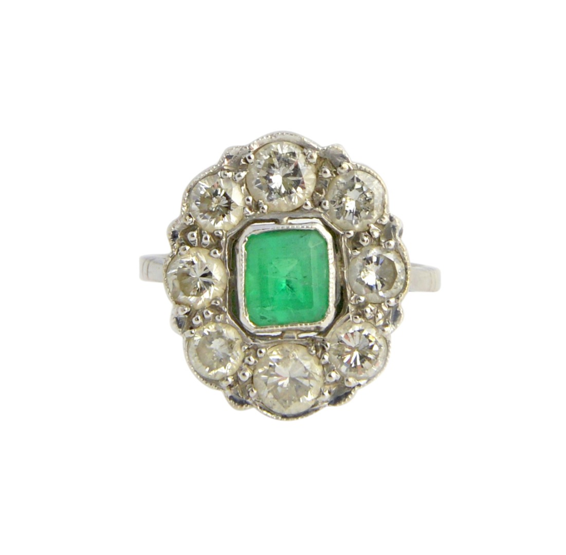 Appraisal: A white gold emerald and diamond oval cluster ring mounted