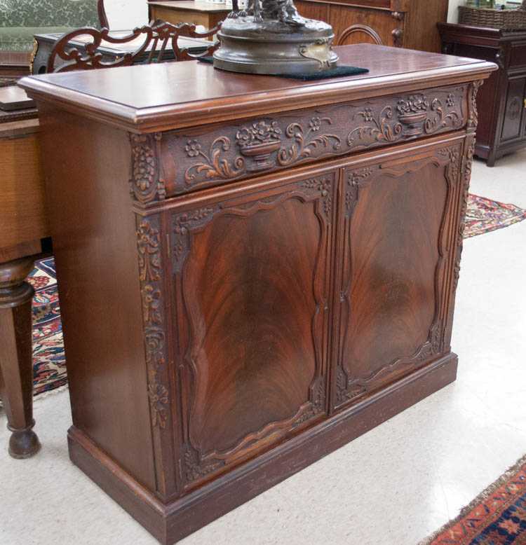 Appraisal: CARVED MAHOGANY SIDE CABINET American mid- th century the long