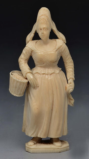 Appraisal: A FRENCH SMALL CARVED IVORY FIGURE of a Breton lady