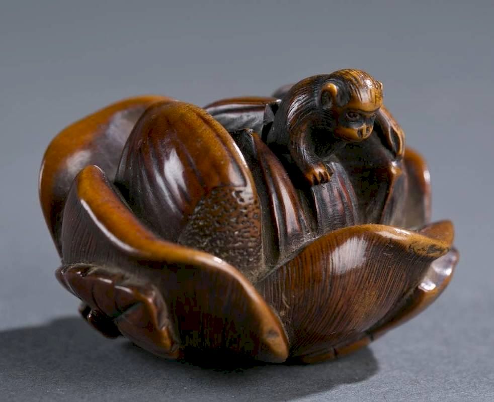 Appraisal: Japanese wood netsuke of a monkey on a flower A