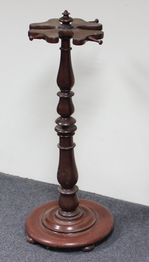 Appraisal: A Victorian mahogany stick stand on turned stem and base