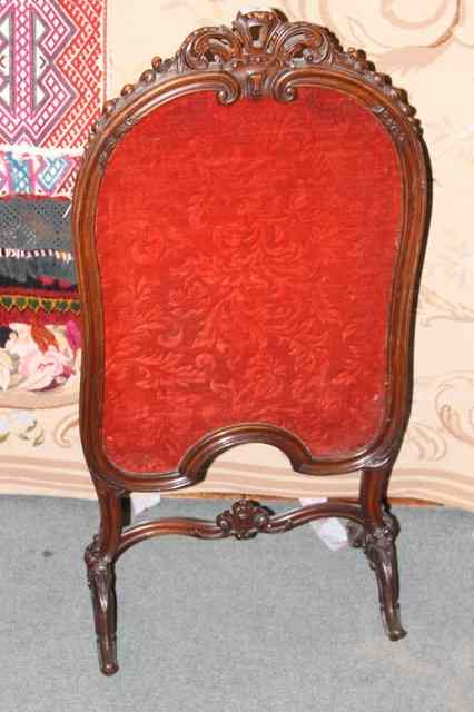 Appraisal: A VICTORIAN WALNUT FIRE SCREEN with shaped supports carved decoration