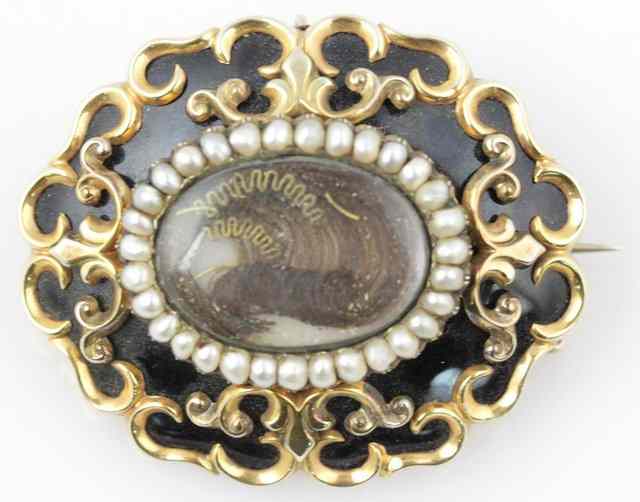 Appraisal: A Victorian mourning brooch centred by a hair set panel