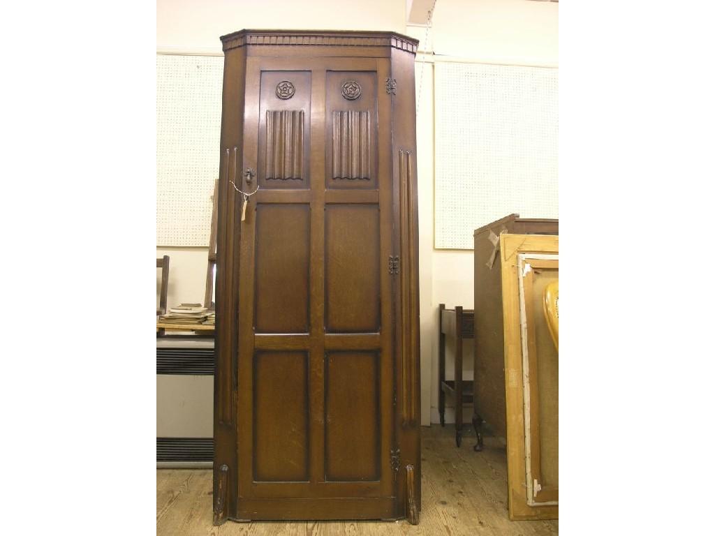 Appraisal: A dark oak hall wardrobe enclosed by full-length panel door