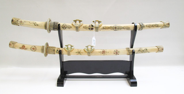 Appraisal: CHINESE CARVED BONE SWORD SET two swords with scrimshaw designs