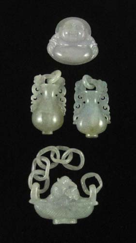 Appraisal: FOUR CHINESE CARVED JADE PENDANTS together weighing grams The light