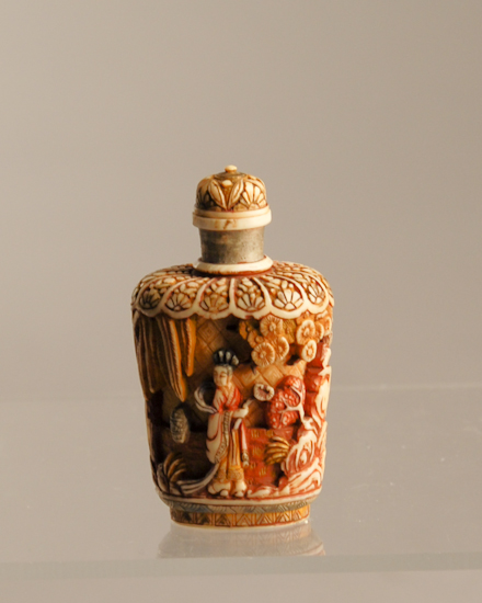 Appraisal: A Carved Polychromed Ivory Snuff Bottle having deep relief carvings