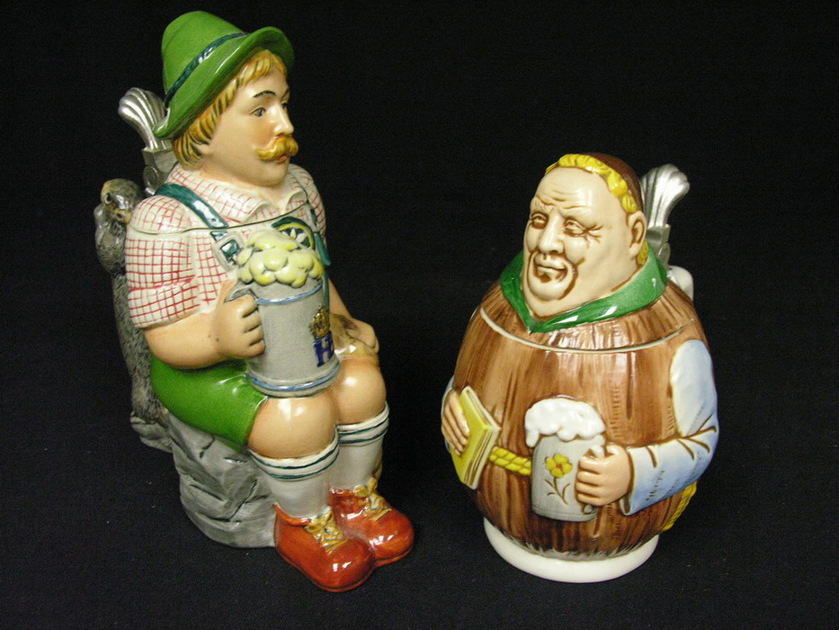 Appraisal: PAIR FIGURAL GERMAN STEINS AND