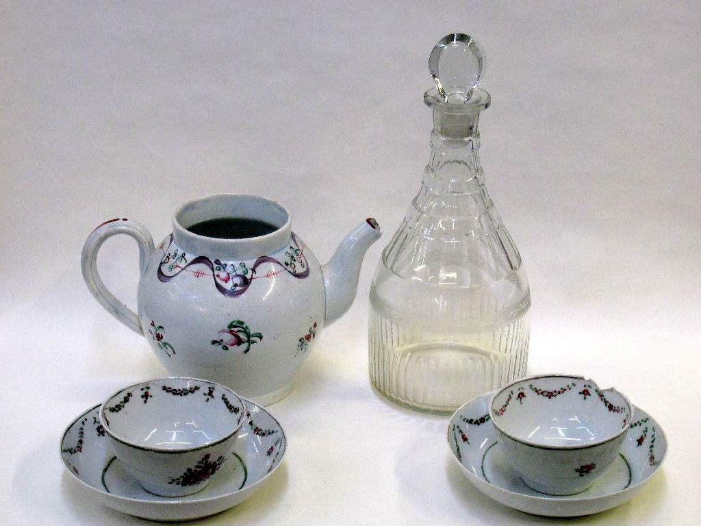 Appraisal: English handpainted teapot def and two teabowls and saucers and