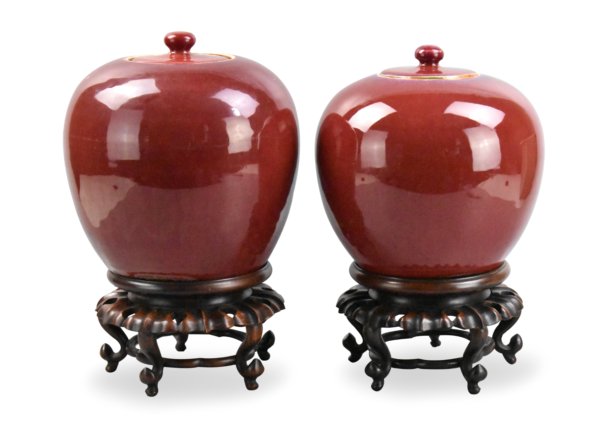 Appraisal: Two Chinese flambe glazed covered jars with wooden stands dating