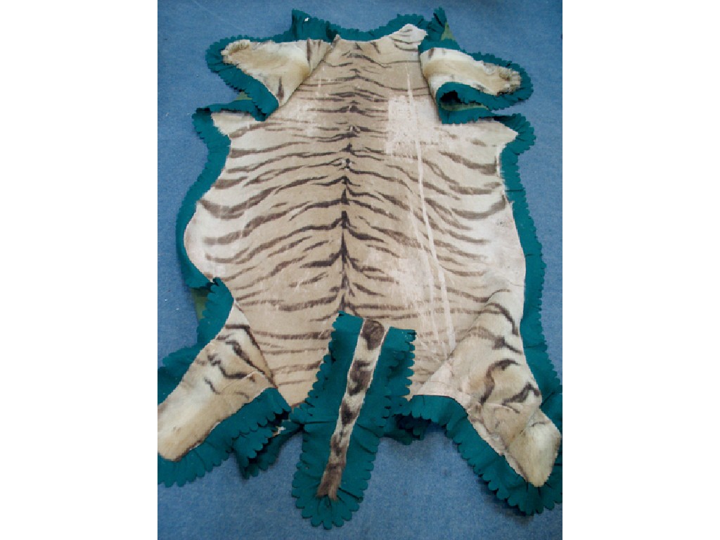 Appraisal: A TIGER SKIN RUG mounted on green backing with frilled