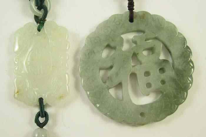 Appraisal: TWO CHINESE CARVED JADE PENDANTS the first round '' diameter