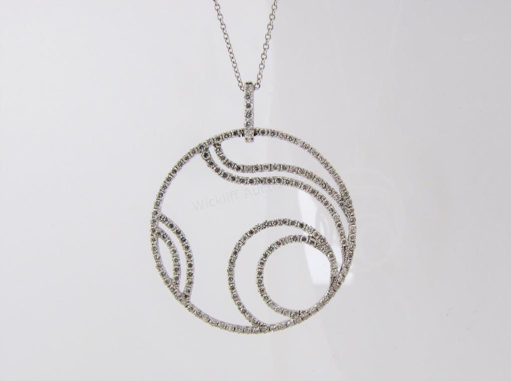 Appraisal: An K white gold circle pendant with swirl design by