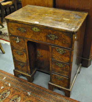 Appraisal: An th century walnut kneehole desk fitted with a secretaire