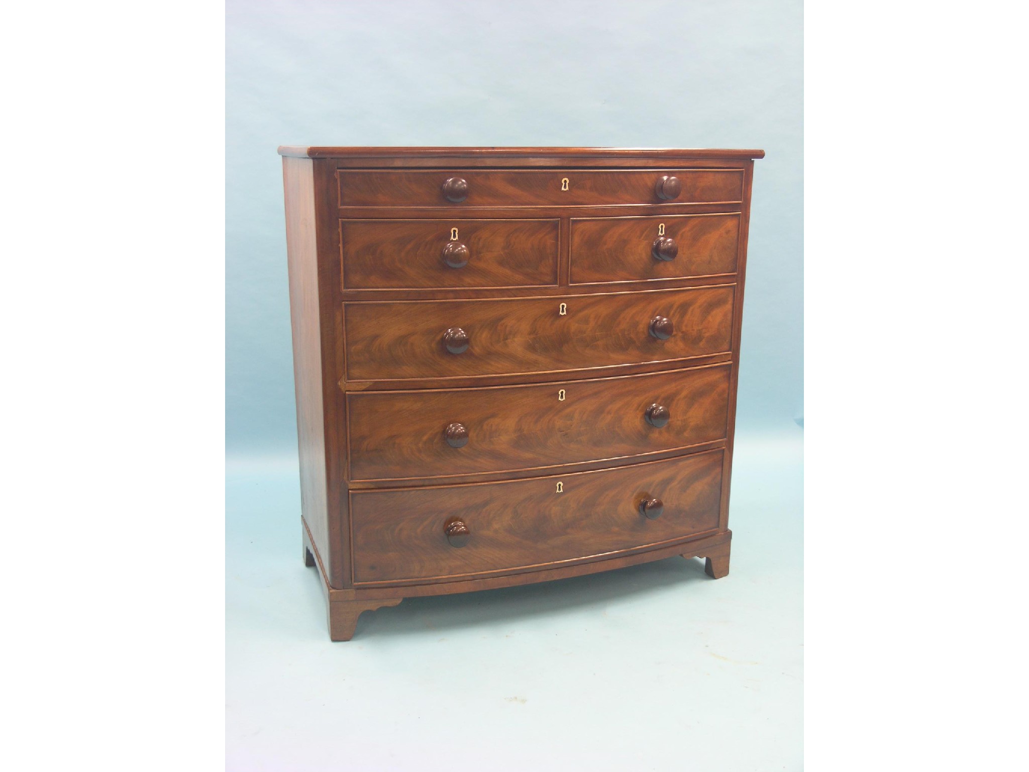 Appraisal: An early Victorian mahogany bow-fronted chest shallow upper drawer above