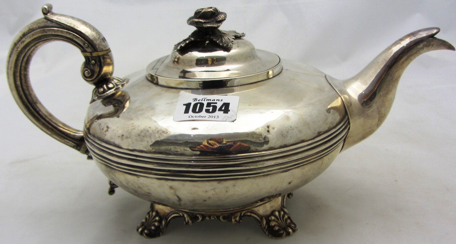 Appraisal: A silver teapot of compressed circular form raised on scalloped