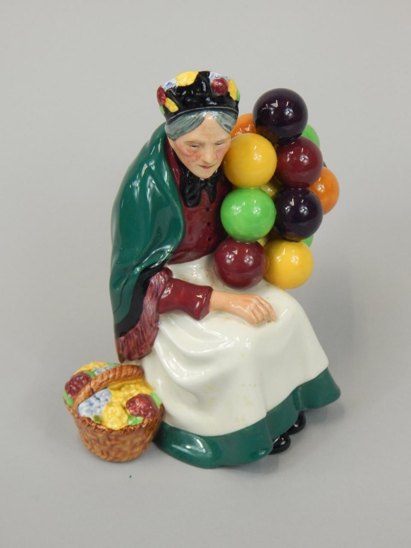 Appraisal: A Royal Doulton figure The Old Balloon Seller HN green