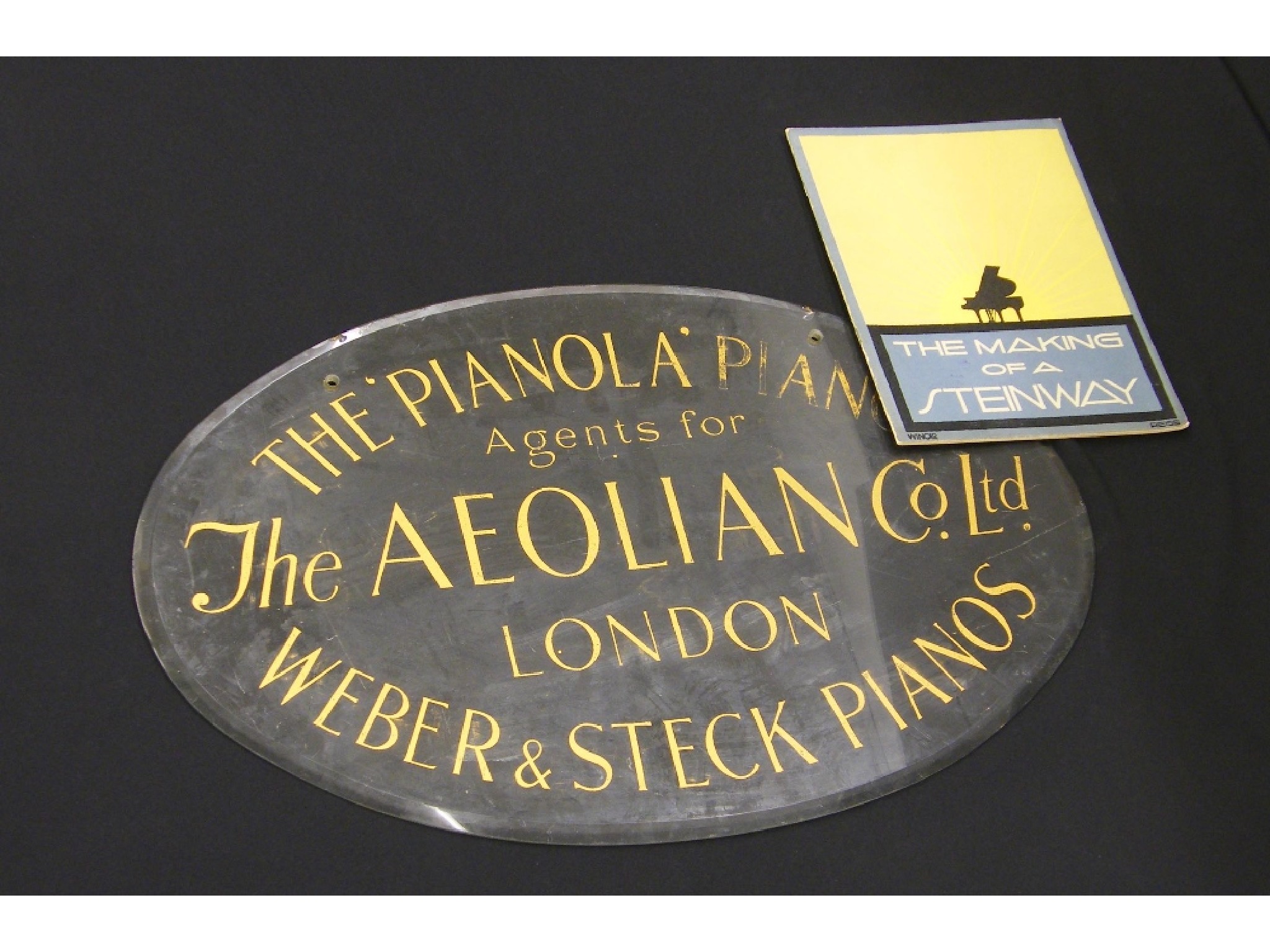 Appraisal: Oval clear glass bevelled edge advertising sign inscribed The Pianola