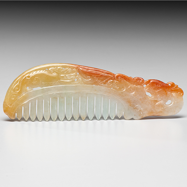 Appraisal: Chinese A carved red and yellow jadeite comb with incised