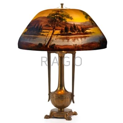 Appraisal: MOE BRIDGES Table lamp its shade reverse-painted with lake scene